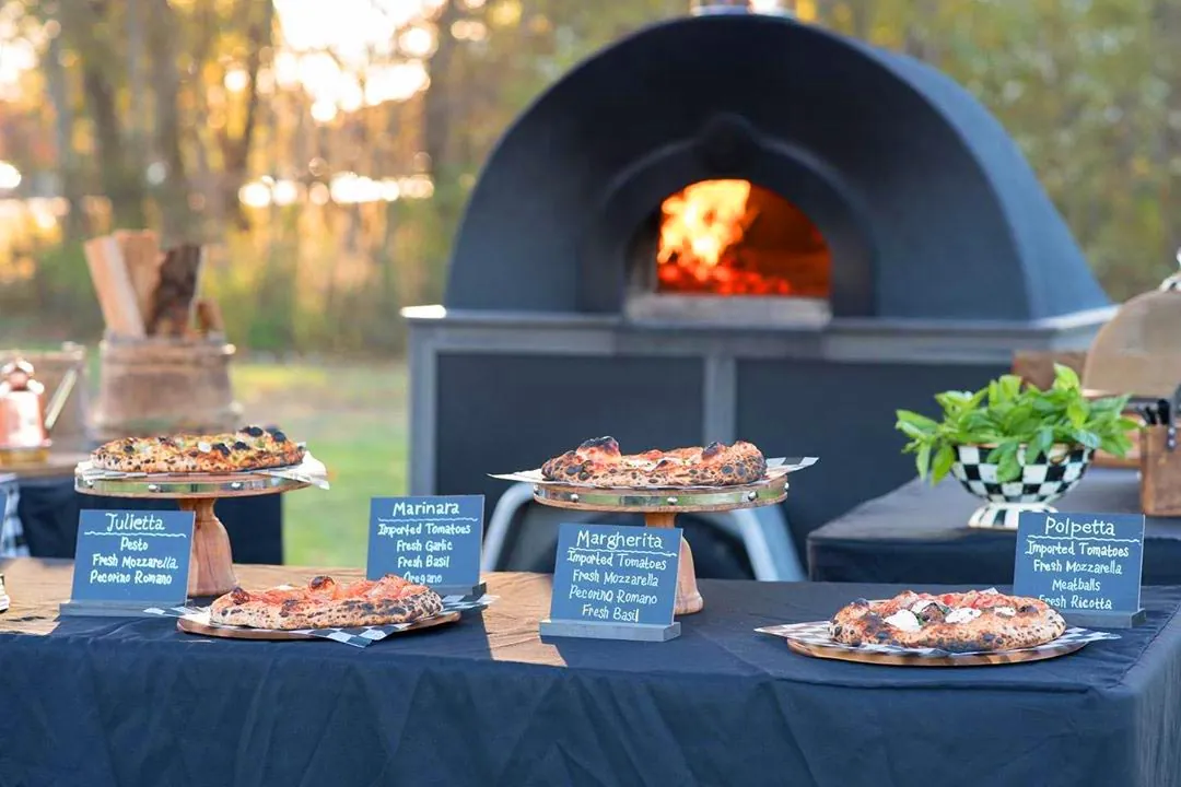 The mobile wood-fired oven set up at a catering event