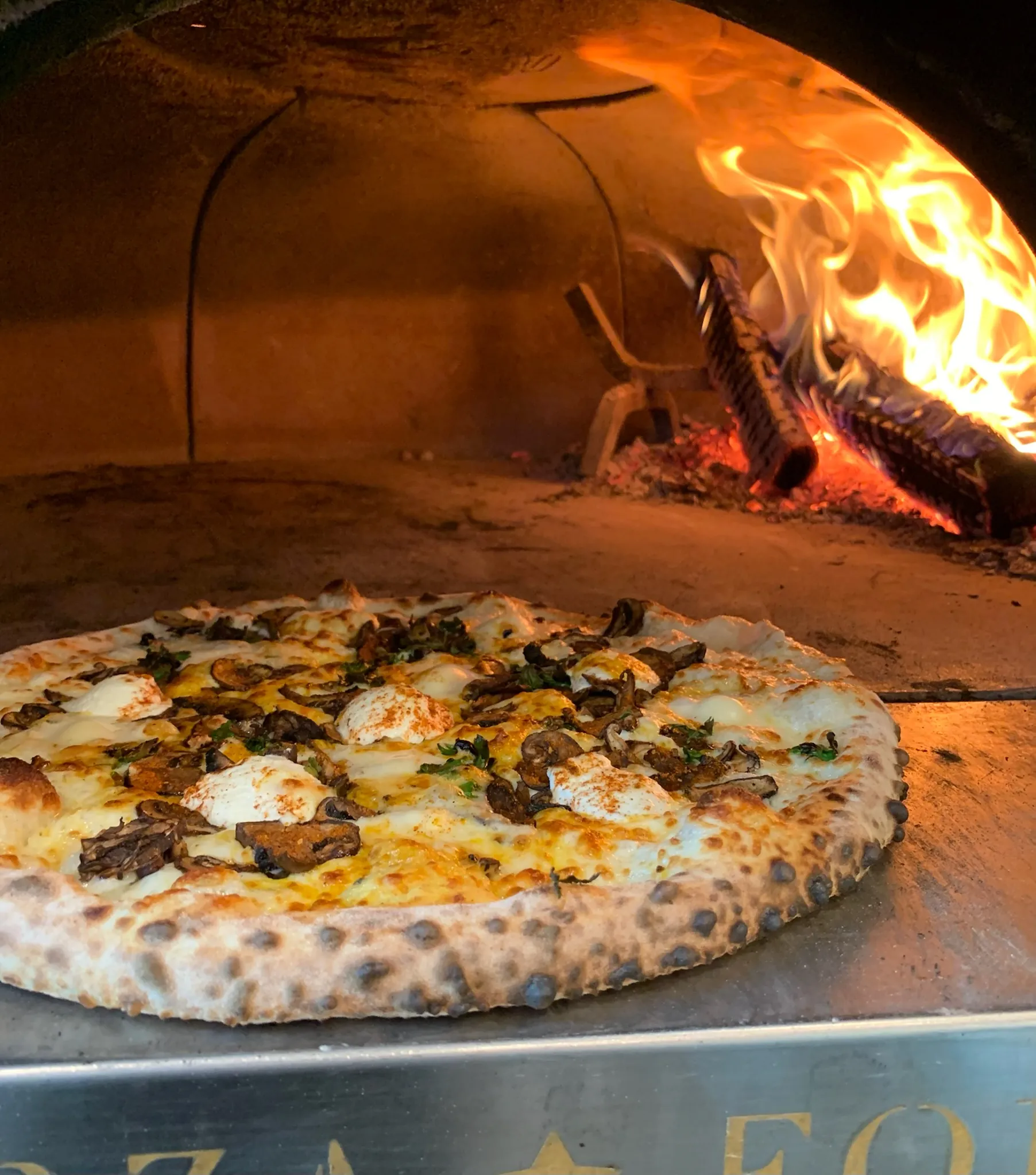 Wood-fired pizza fresh from the flames